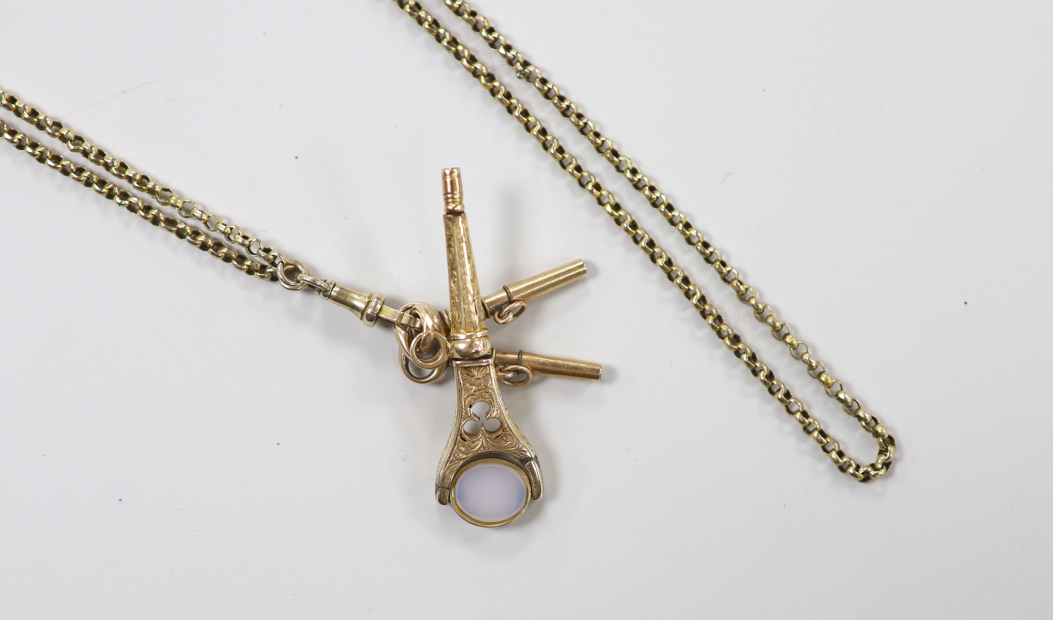 An Edwardian yellow metal guard chain, 170cm, 21.6 grams, hung with three yellow metal overlaid watch key fobs, one with set with bloodstone and carnelian stones